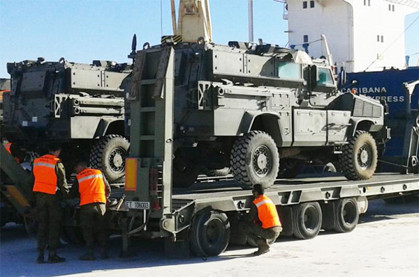 MRAPs are loaded after arriving by sea