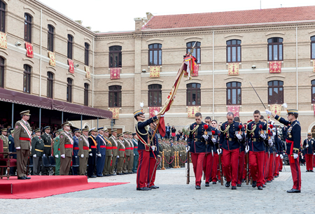 The formation of cadets defile under the flag