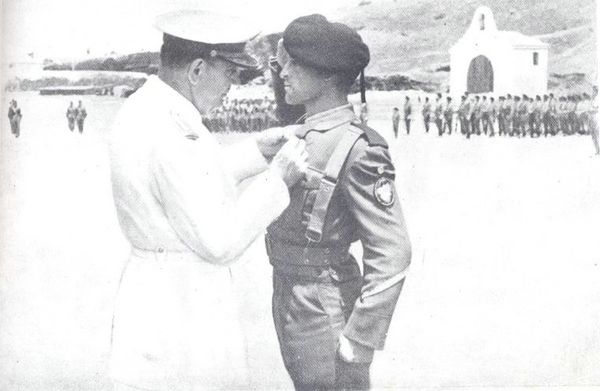 Bestowing the award upon the soldier.